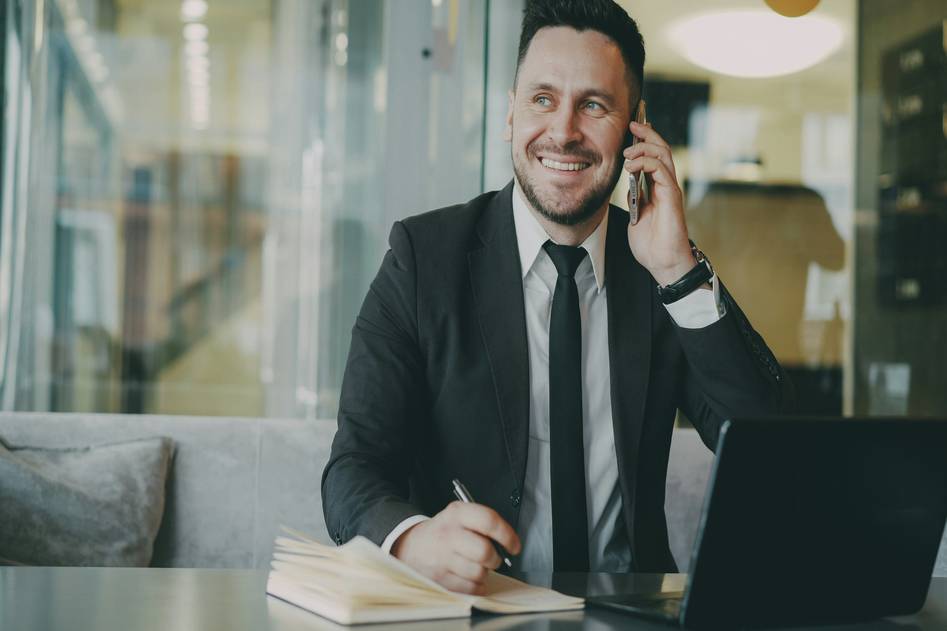 Business professional using advanced VoIP phone system on desk